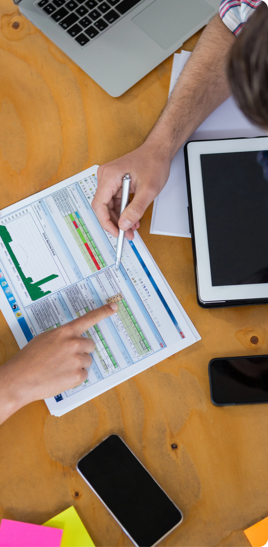 Business Executives Discussing Charts Graphs Desk